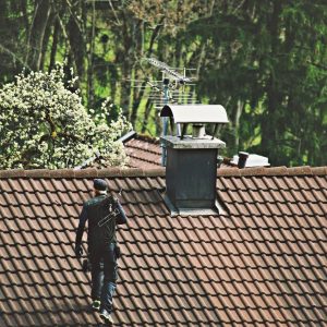 high-angle-view-chimney-sweep-walking-roof